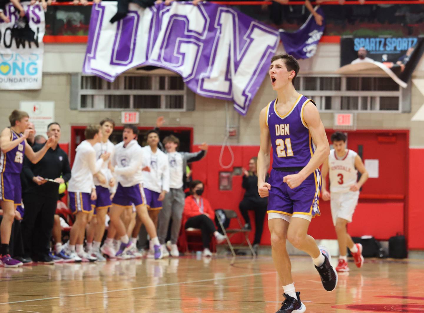 Downers Grove North's Jack Stanton (21) reacts to a three-point play during the boys 4A varsity sectional final game between Hinsdale Central and Downers Grove North high schools in Hinsdale on Friday, March 3, 2023.