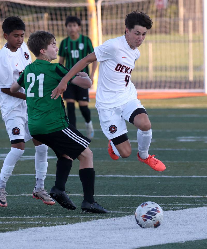 DeKalb's Zachariah Murray hurdles the leg of St. Edward's Will Kindelin Thursday, Aug. 28, 2025, during their game in the Barb Cup tournament at DeKalb High School.