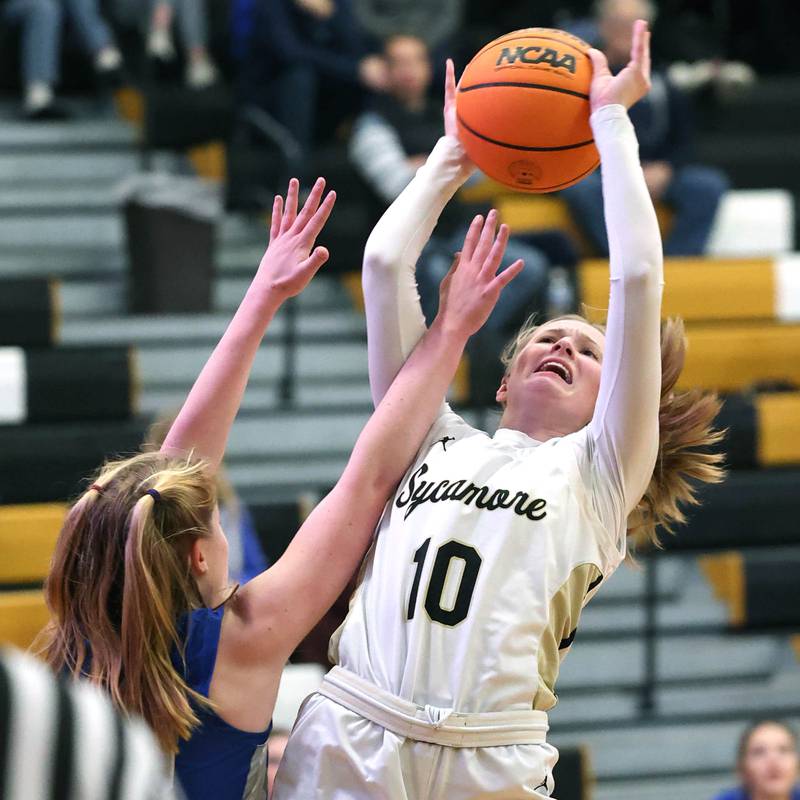 Sycamore's Lexi Carlsen is fouled by St. Francis' Lynsey Cleveland as she goes to the basket during their game Thursday, Jan. 4, 2023, at Sycamore High School.