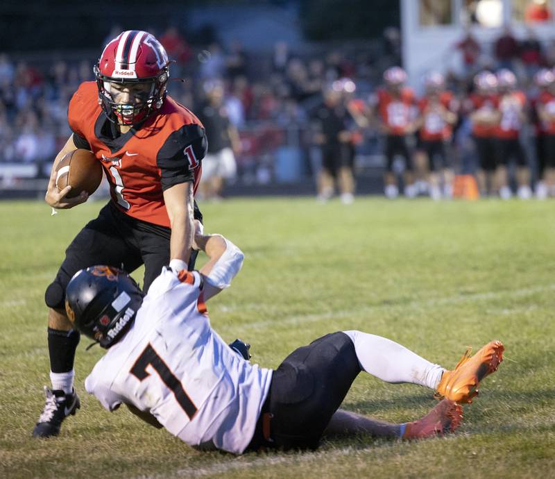Amboy’s Jose Lopez is pulled down by Milledgeville’s Konner Johnson Friday, August 29, 2025, in Amboy.