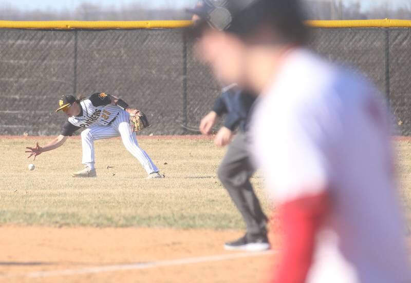 Putnam County's Tayton Kays bare hands the ball in the outfield from a hit by Hall's Braden Curran on Monday, March 17, 2025 at Putnam County High School.