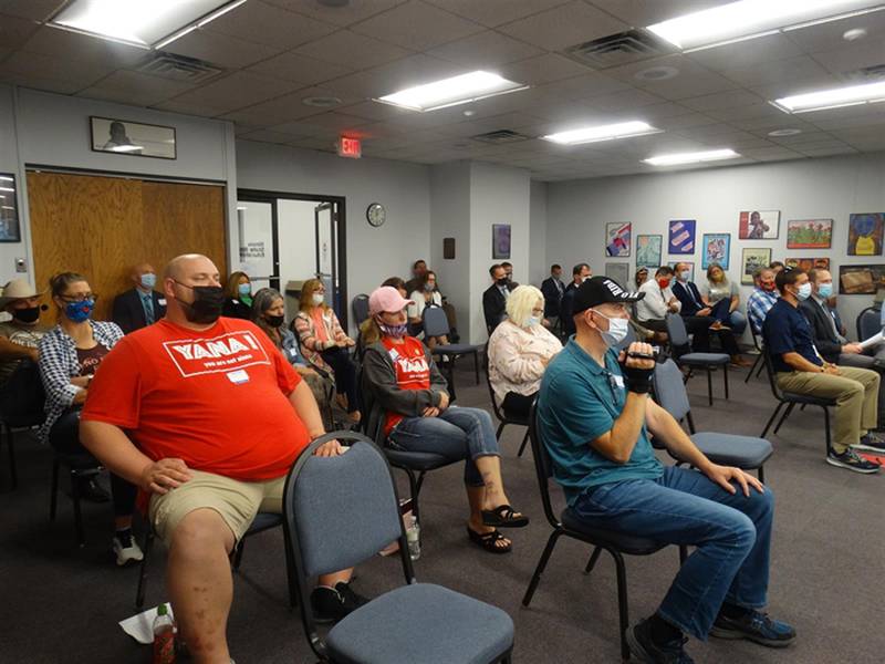 Dozens of people crowd into the Illinois State Board of Education meeting Wednesday in Springfield to protest a universal mask mandate now in place for all public and nonpublic schools in the state.