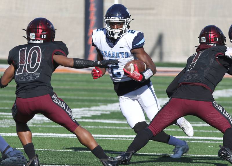 Nazareth's Justin Taylor makes a move on Peoria's Kenny Rutherford during their IHSA Class 5A state championship game Saturday, Nov. 26, 2022, in Memorial Stadium at the University of Illinois in Champaign.