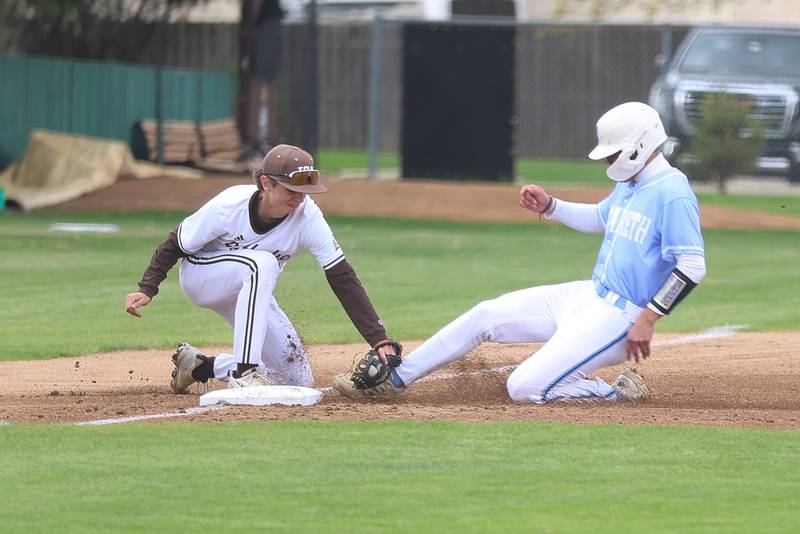 Joliet Catholic’s Johnny Curbis tags out the Nazareth runner at third on Wednesday, April 29, 2026 in Joliet.