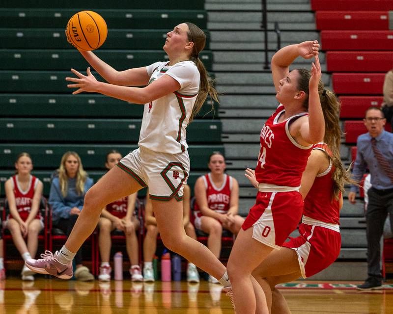 Alexus Hines (4) of LaSalle-Peru lays ball up as Ottawa's defense trails on Wednesday, December 17, 2025 at Sellet Gymnasium in LaSalle.