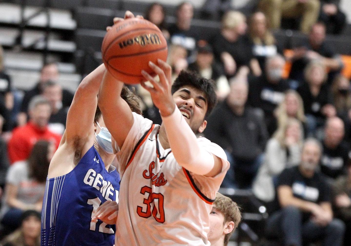 St. Charles East’s Rahul Gor (3) grabs a rebound from Geneva’s Ryan Huskey during a game at St. Charles East on Tuesday, Feb. 8, 2022.