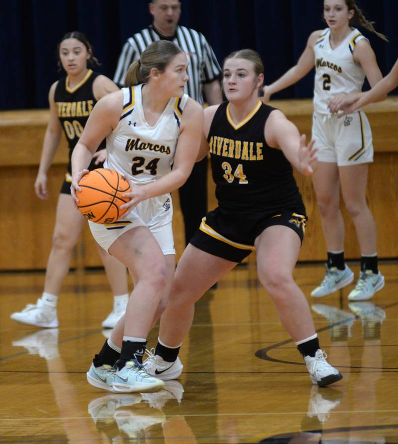 Polo's Katelyn Rockwood looks to pass as Riverdale's Brooklyn Peterson defends during a Saturday, Jan. 18, 2025 game at Polo High School.
