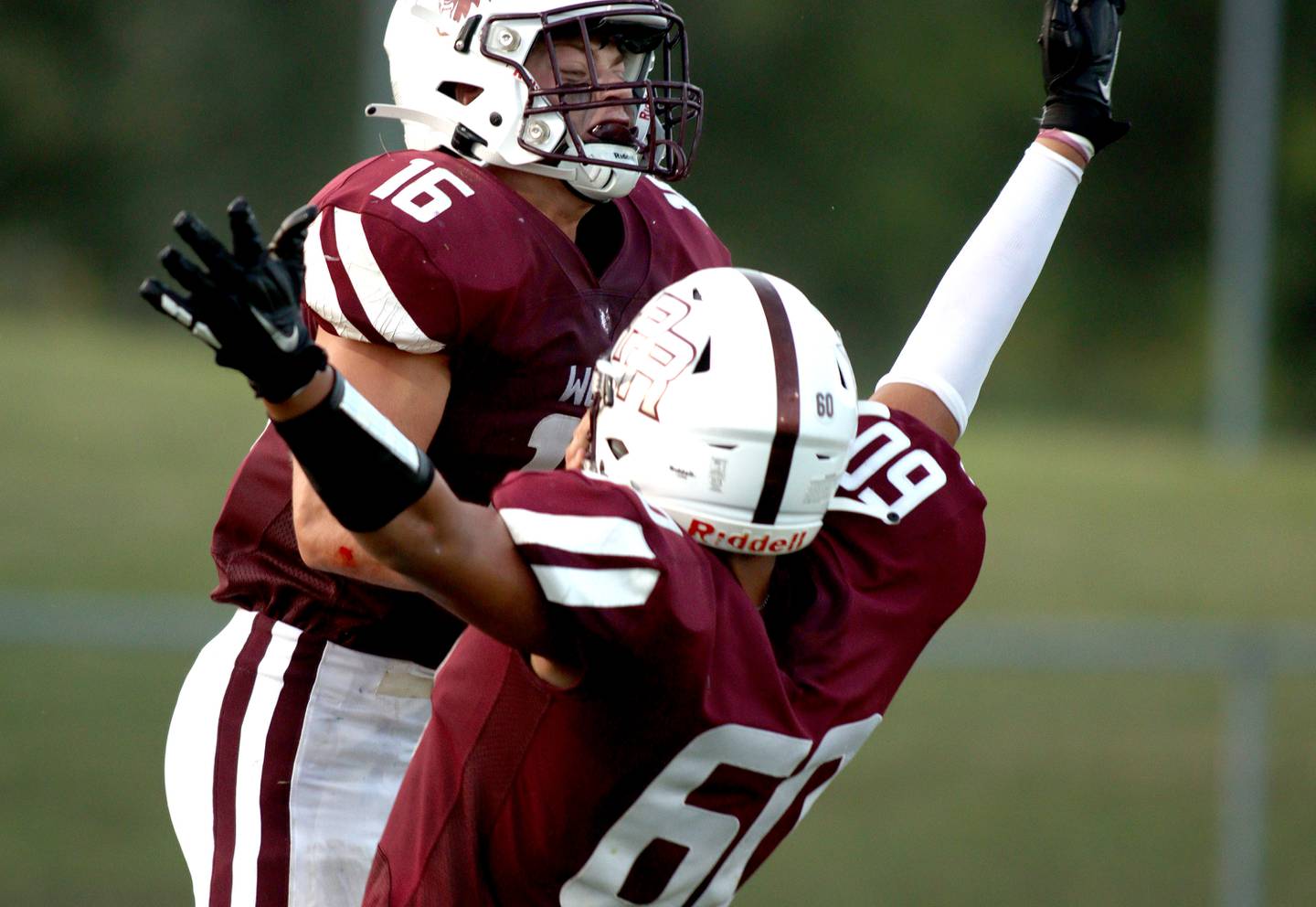 Prairie Ridge’s Dominic Creatore, left, is greeted by Fernando Rodriguez after a touchdown against Jacobs at Crystal Lake Friday night.
