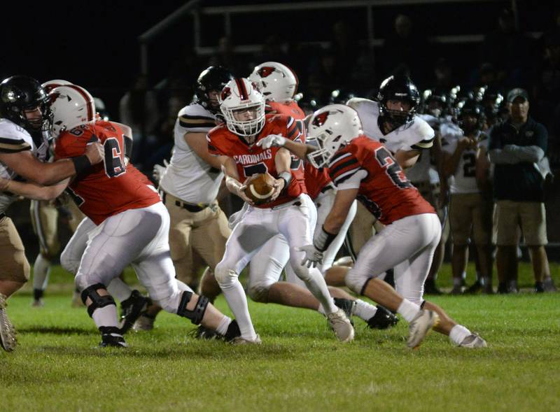 Forreston quarterback Brady Gill hands the ball off to Kayden Loomis during Friday, Aug, 29, 2025 action with Lena-Winslow at Forreston High School.