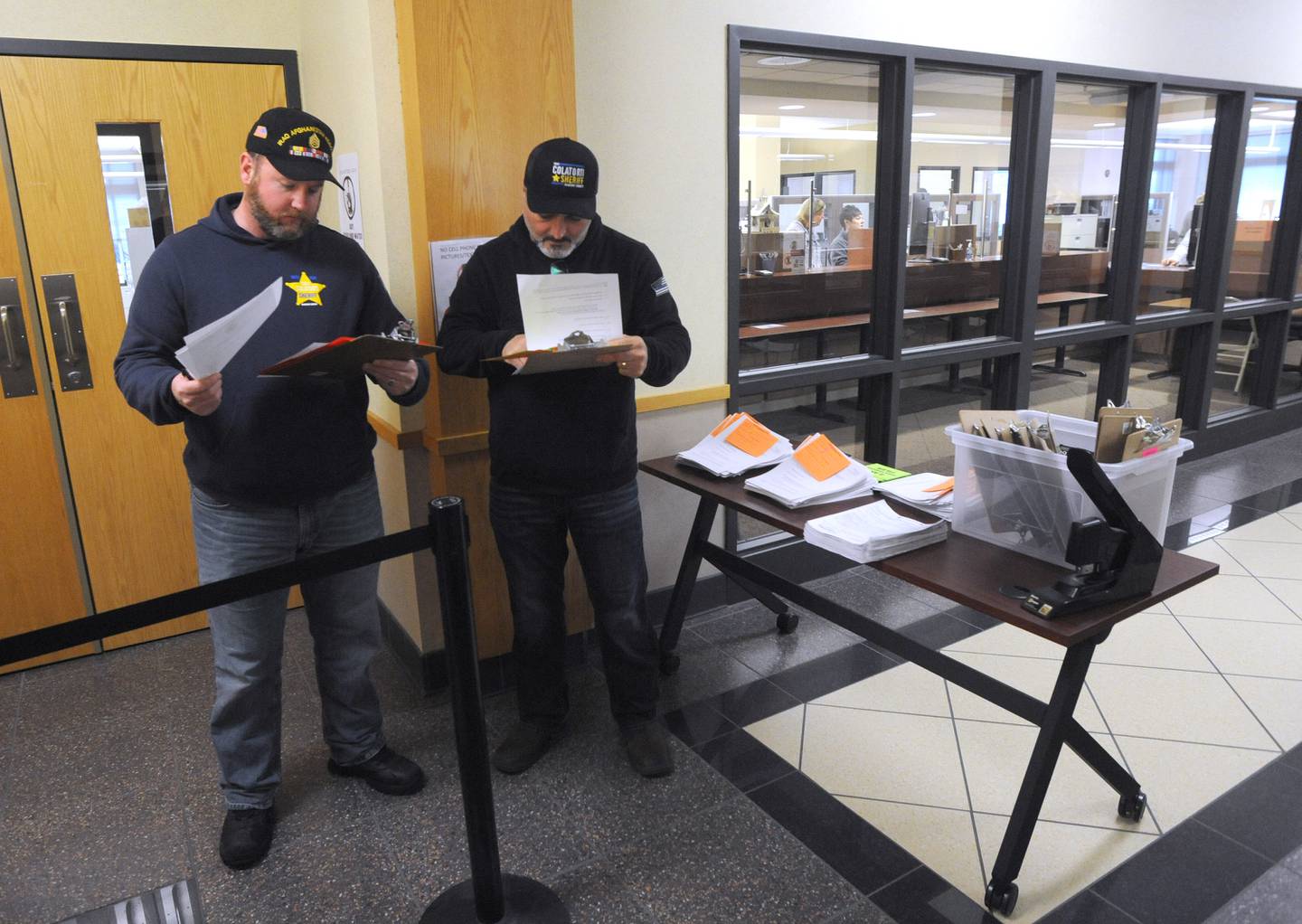 McHenry County sheriff candidate Tony Colatorti, right, and his campaign manager Kevin Byrnes look over the candidacy forms the morning of Monday, March, 7, 2022, at the McHenry County Clerk's Office in Woodstock. Monday was the first day for candidates to file ahead of the June primaries. This election season includes all McHenry County Board seats, the clerk, sheriff and regional superintendent of education. The candidates were trying to get the first slot on the ballot by filling at 8 a.m. When more than candidate applies at a time, a lottery is held.