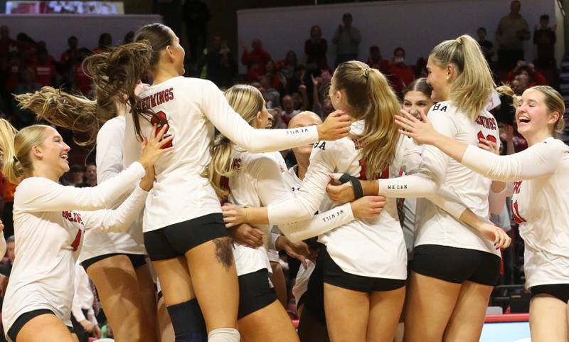 Members of the Benet Academy volleyball team celebrate after defeating Huntley during the Class 4A State semifinal game on Friday, Nov. 15, 2024 at CEFCU Arena in Normal.