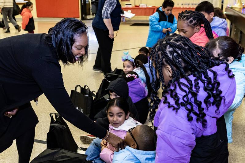 Principal Kesha Brown makes sure the first graders coats are a perfect fit during the winter coat event hosted by Nicor Gas, in collaboration with Operation Warm, at T. E. Culbertson Elementary School on Nov. 7, 2025.