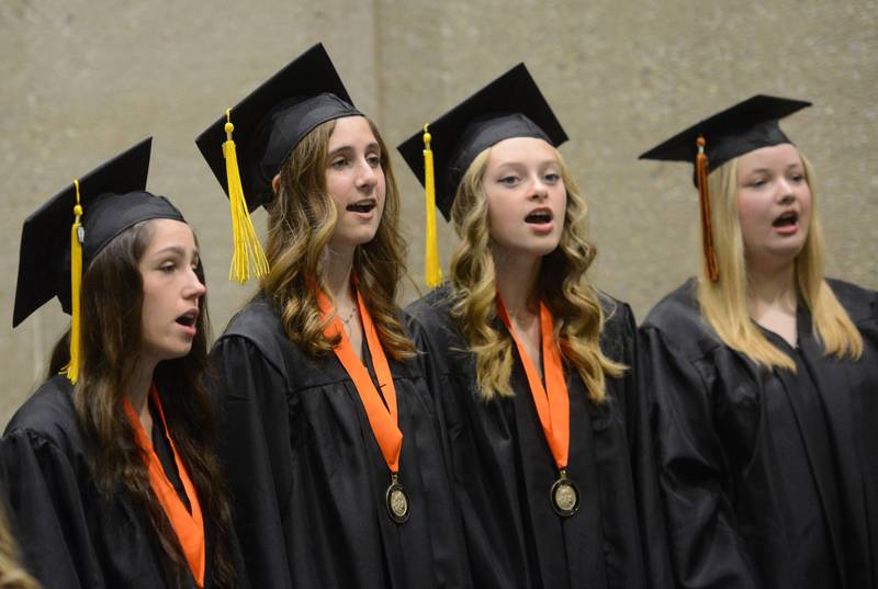 Joe Lewnard/jlewnard@dailyherald.com
Members of the Senior Choir sing prior to the start of the Wheaton Warrenville South High School graduation, held at the College of Dupage in Glen Ellyn Saturday.