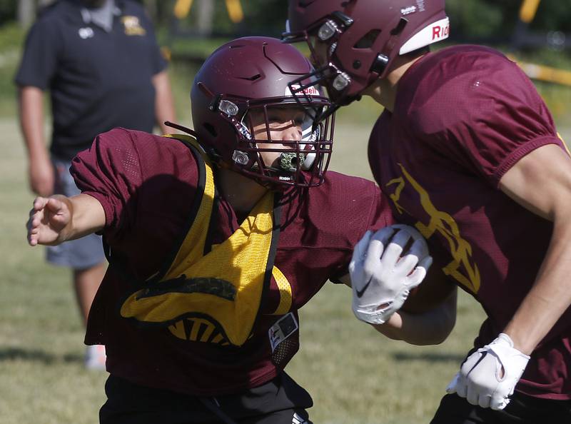 Richmond-Burton’s Nick Falasca tackles the runner during summer football practice Thursday, July 14, 2022, at Richmond-Burton High School in Richmond.