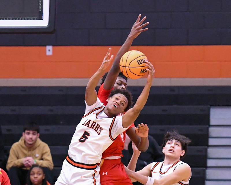 DeKalb's Bryan Miller (5) grabs a rebound while being defended by a Jefferson defender during the 3A  regional semifinal game on Wednesday Feb. 25, 2026, held at DeKalb High School.