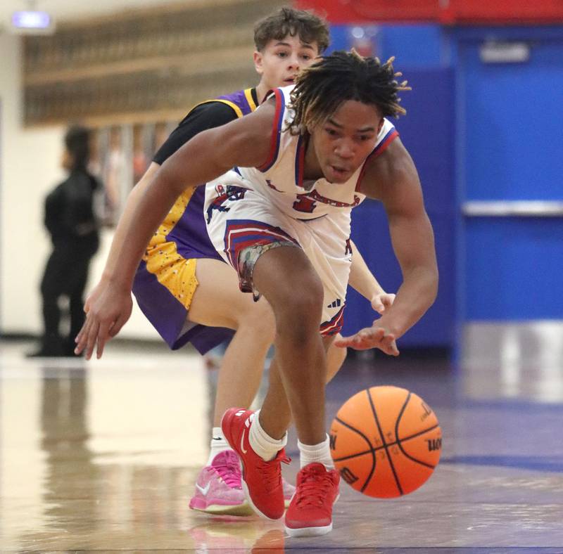 Dundee-Crown’s Rasheed Trice corrals the ball against Wauconda in varsity basketball Friday, Dec. 20, 2024 at Dundee-Crown High School in Carpentersville.