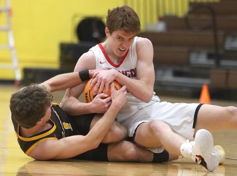 Jacobs’ Ben Jurzak, left, battles Barrington’s Adam Baird during Hinkle Holiday Classic varsity boys basketball tournament action on Monday, Dec. 23, 2024 at Jacobs High School in Algonquin.