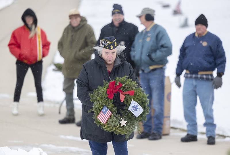 Coast Guard representative Melanie Willstead places a wreath Saturday, Dec. 13, 2025, at Palmyra Cemetery in Dixon as part of the Wreaths Across America ceremony.