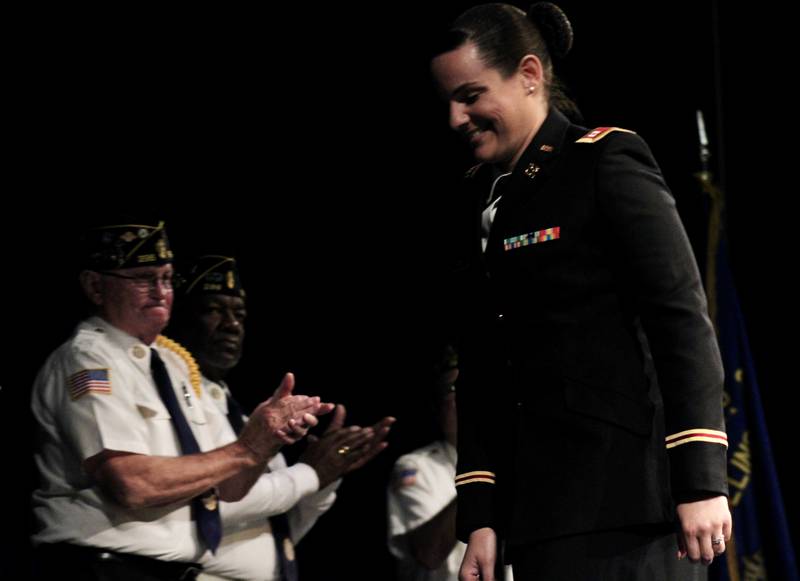Capt. Taylor J-Beebe Cox bows her head after accepting applause for her Veterans Day address on Friday, Nov. 11, 2022 at Sterling High School Centennial Auditorium. This is the second year Cox, a logistics officer at Rock Island Arsenal, has provided the address.
