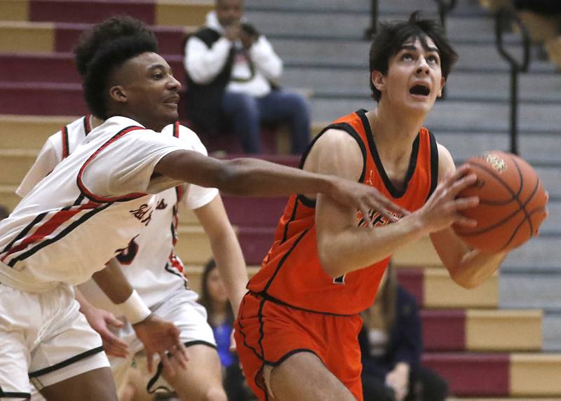 McHenry's Hayden Stone shoots over Huntley's Lucas Crosby during a Fox Valley Conference boys basketball game Wednesday, Jan. 10, 2024, at Huntley High School.