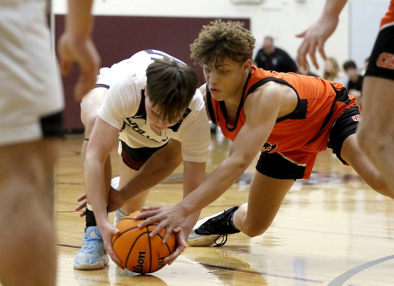 Prairie Ridge's Owen Voight battles with Crystal Lake Central's Avery Lee for a loose ball during an IHSA Class 3A Prairie Ridge Regional basketball game on Monday, Feb. 24, 2025, at Prairie Ridge High School.