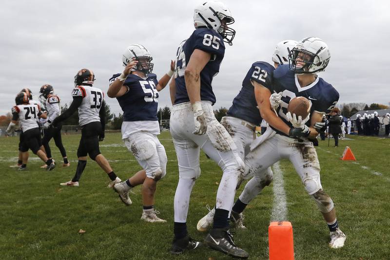 Cary-Grove's Drew Magel, right, is swarmed by teammates after scoring a touchdown against Crystal Lake Central during their playoff football game at Cary-Grove High School on Saturday, Nov. 13, 2021 in Cary.  Cary-Grove beat Crystal Lake Central 42-21 and will advance to meet Lake Forest next week.