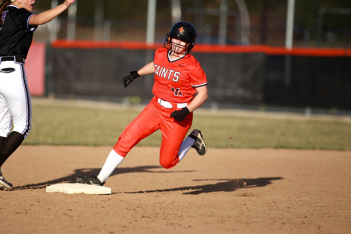 St. Charles East's Taylor Grendzinski rounds second base during a game against Downers Grove North on Friday, March 28, 2025 in St. Charles.