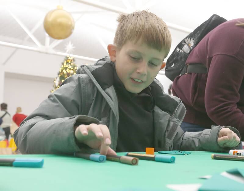 Calvin Martin of Marseilles makes an ornament at Ax Church during the Miracle on First Street event on Saturday, Dec. 2, 2023 in La Salle.