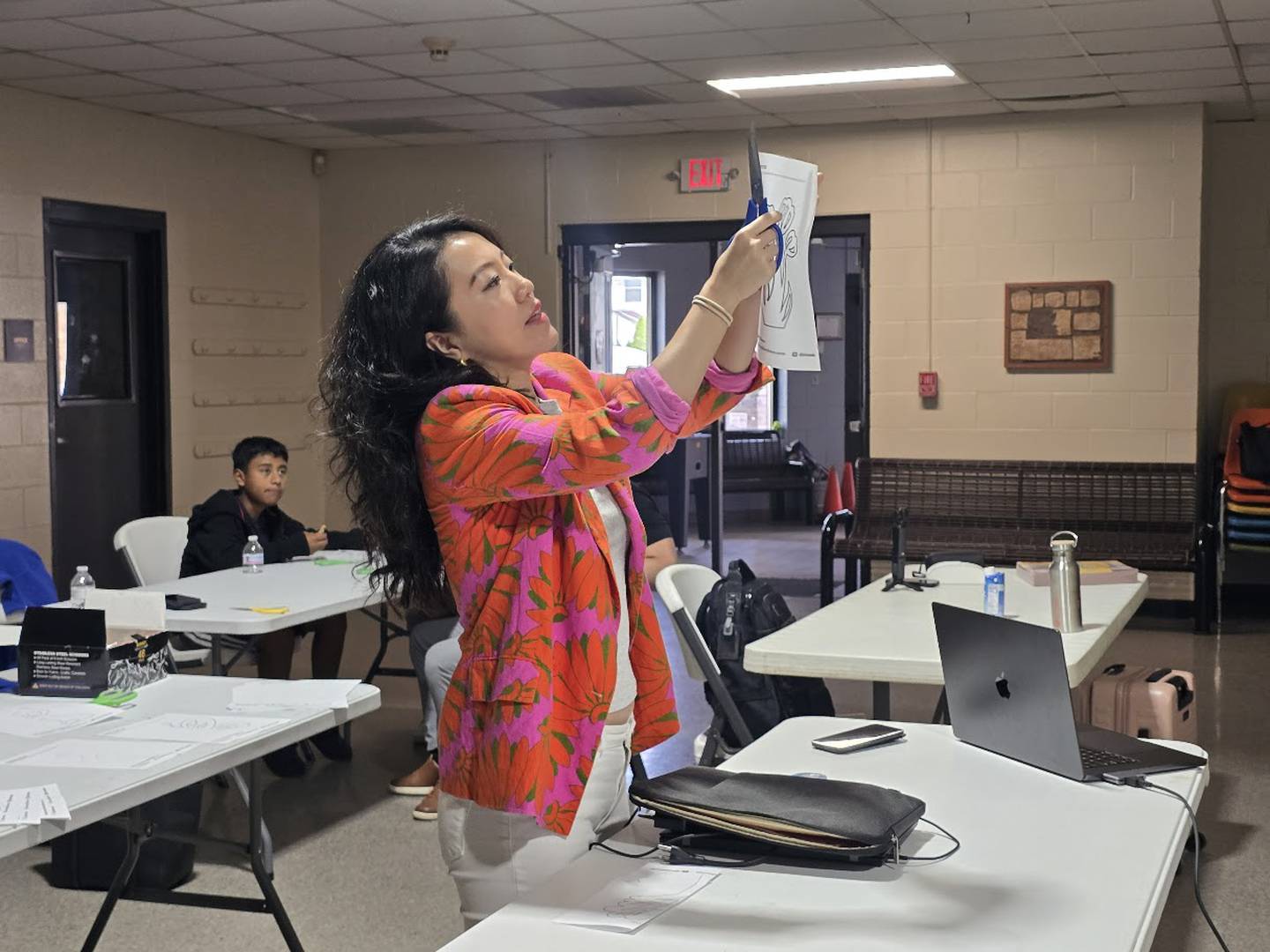 Sijia Chen, the Los Angeles-based multimedia artist for the Dome of Unity sculpture for Joliet’s $9 million city square, demonstrates the ancient art of paper cutting at a public art workshop on Saturday, Oct. 18, 2025, in Joliet.