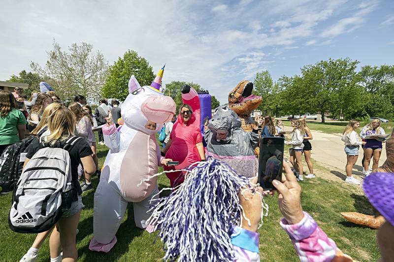 Christy Zepezauer as the Unicorn, Jenny Conderman as the Flamingo, Paige Toms as the Ballerina Hippo and and Brittany Geiger as the T-Rex pose for photos outside of Reagan Middle School Thursday, May 25, 2023.