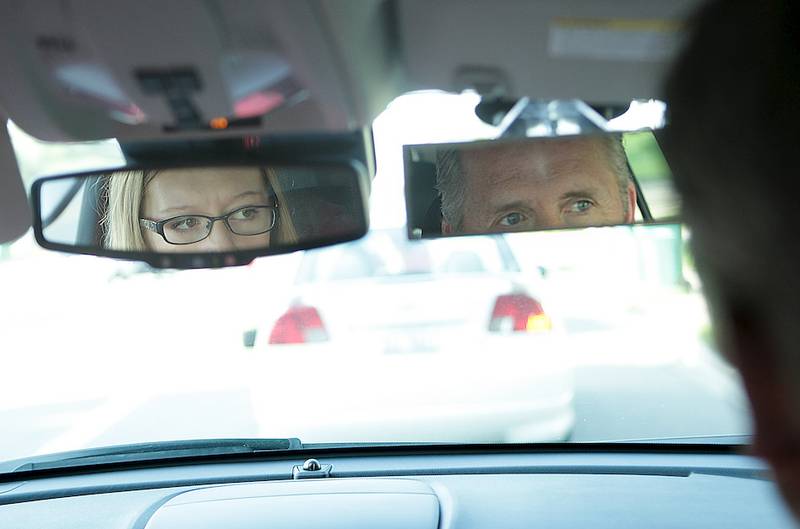 DeKalb sophomore Chloe O'Dell, 15, checks her mirror at a stop during her driving time Friday with DeKalb High School driver education instructor John Cordes in DeKalb.