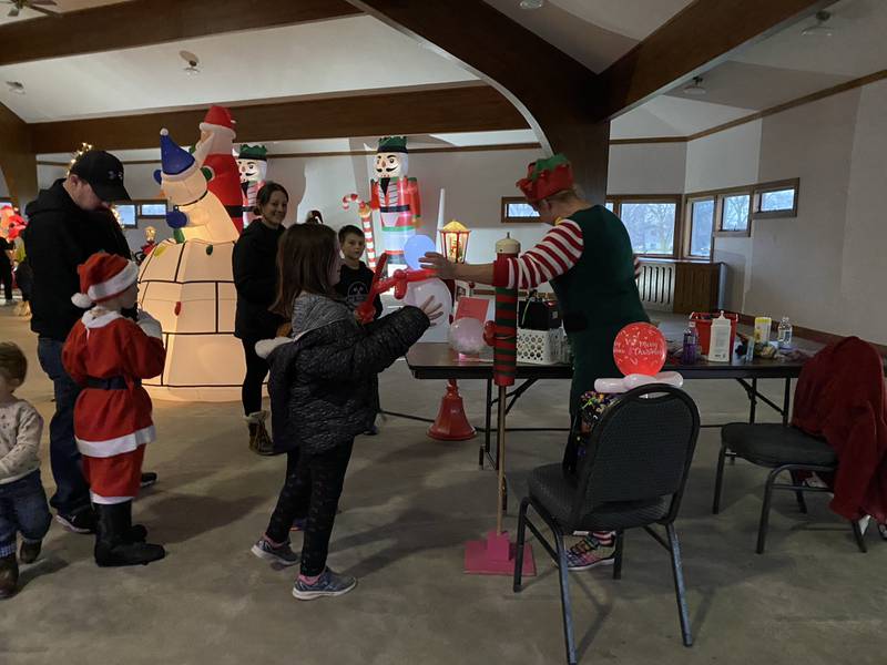 Audrey waits patiently for her balloon animal during An Evening with Santa Claus.