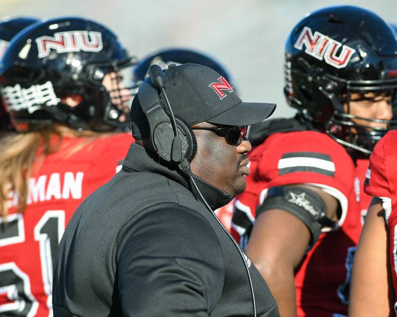 NIU head football coach Thomas Hammock listens as other NIU coaches talk with the team as there was a break in the action during the second quarter Saturday Nov. 26th at Huskies stadium in DeKalb.