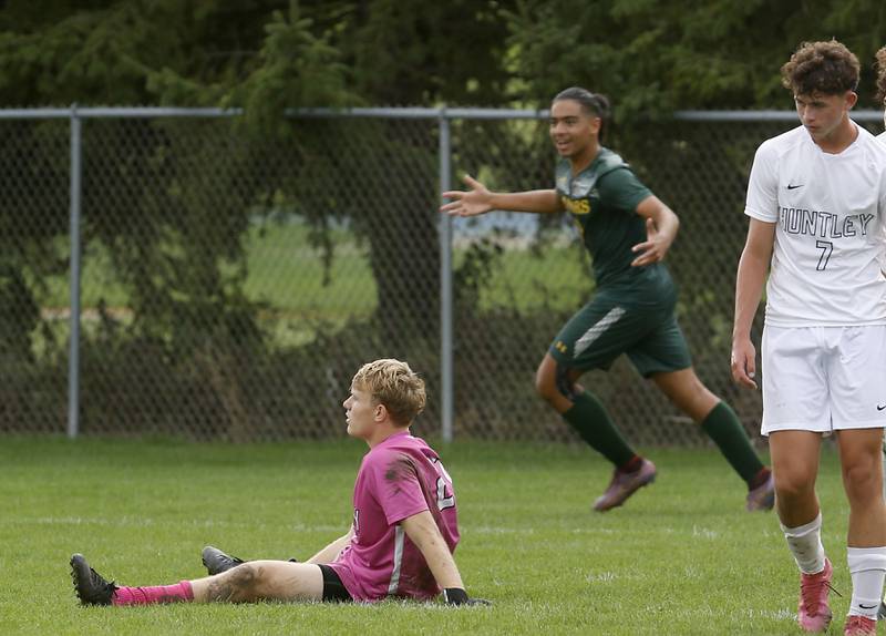 Huntley's Jack Bakey sits on the ground as Crystal Lake South's Ali Ahmed celebrates a goal during a Fox Valley Conference soccer match on Thursday, Sept. 28, 2023, at Crystal Lake South High School.