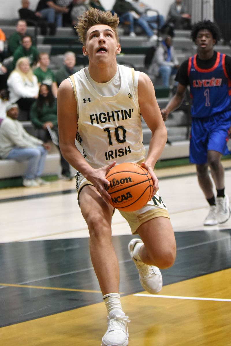 Bishop McNamara's Coen Demack gathers his drive at the basket during a home game agaisnt Lycee Francais de Chicago Wednesday, Feb. 18, 2026.