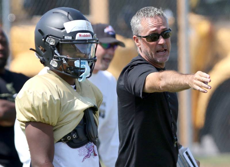Sycamore football head coach Joe Ryan talks to running back Tyler Curtis during practice Monday, July 17, 2023 at the school.
