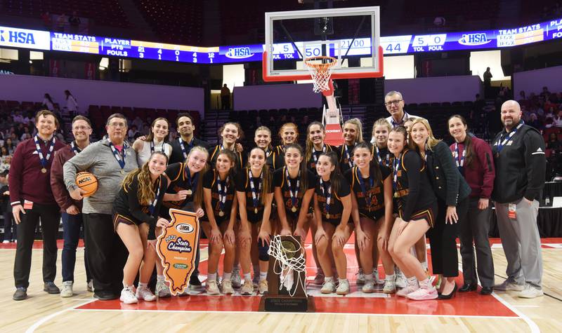 Montini team members pose with their first-place trophy following their 50-44 victory over St. Ignatius during the IHSA Class 3A girls state basketball championship game at CEFCU Arena on Saturday, March 8, 2025 in Normal.