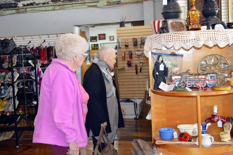 Mary Ann Olson, of Polo, left, and Gail Ludewig, of Polo, peruse items for sale at Gateway Big Box Resale and its sister store, Kim's Gateway Antiques, on April 28, 2023. The stores, which are connected internally, celebrated their one-year anniversaries with a ribbon-cutting. The stores are located at 104 and 108 W. Mason St., respectively.