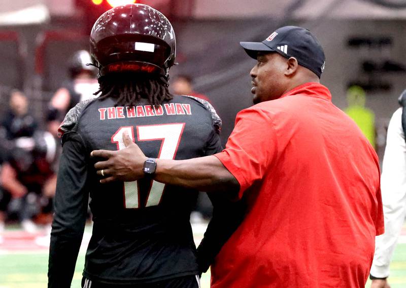 Northern Illinois football head coach Thomas Hammock talks to wide receiver Jamari McIvory during the first spring football practice Thursday, March 27, 2025, in the Chessick Practice Center at NIU in DeKalb.