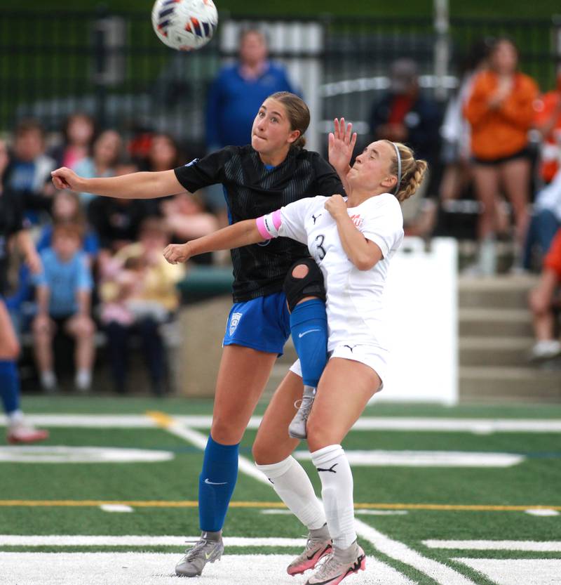 St. Charles North's Maddie Room and Wheaton Warrenville South's Brooke Ittersagen battle for the ball during the Class 3A Glenbard West Sectional final on Friday, May 30, 2025 in Glen Ellyn.