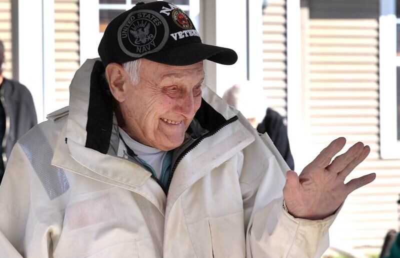 US Navy veteran Richard Korleski, 93, who served in the Korean War, waves to members of the Kunkel family as they ride by in a parade on Veterans Day, Friday, Nov. 11, 2022, for the veterans at the Grand Victorian assisted living facility in Sycamore. Sycamore resident Joann Kunkel read a story in the current Midweek that contained a quote from one of the veterans at the facility that lamented the lack of a parade. So she and her grandkids decided to have one for them.