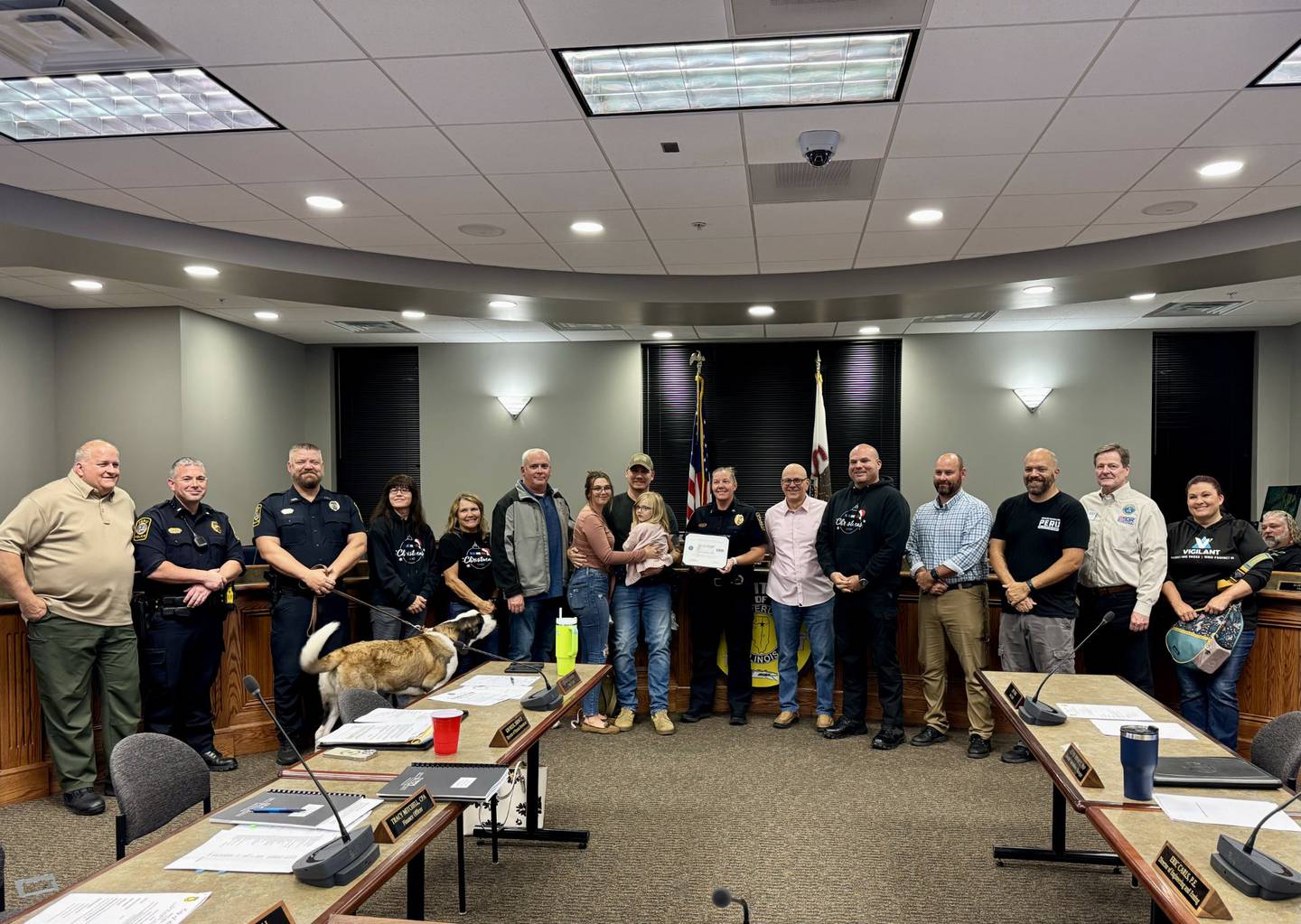 Peru Police Chief Sarah Raymond was “raided” by the police department, friends, council and community members as she was presented a surprise award from the United States Department of Defense during Monday’s council meeting.