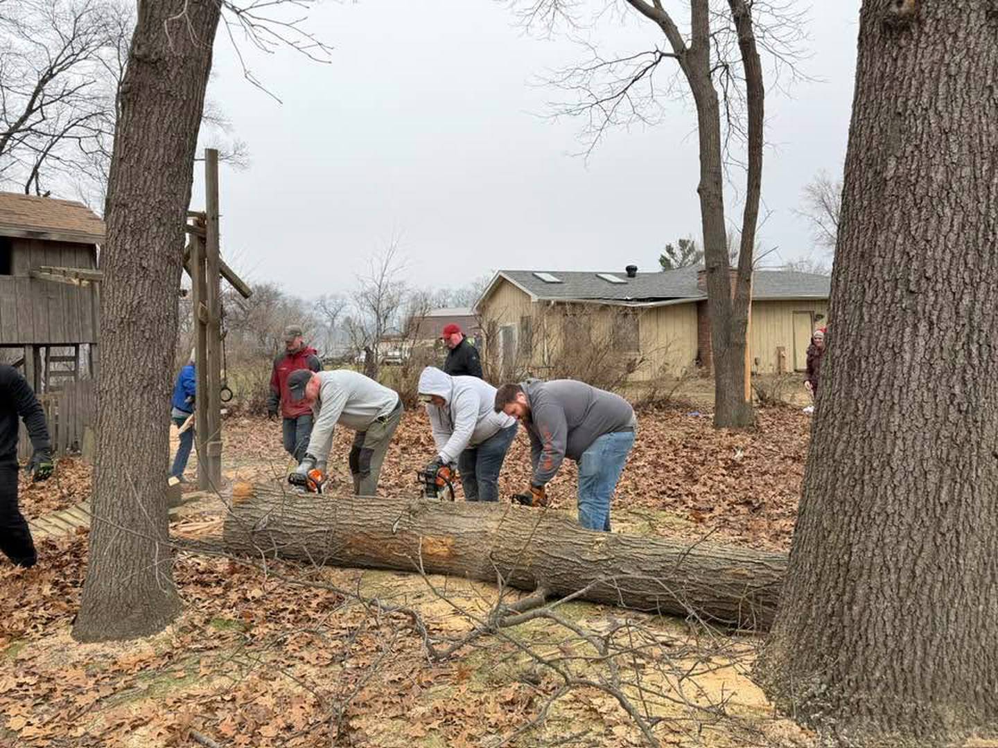 Sean Curbow, right, helps with cleanup following the March 10 tornado that devastated parts of Kankakee County.