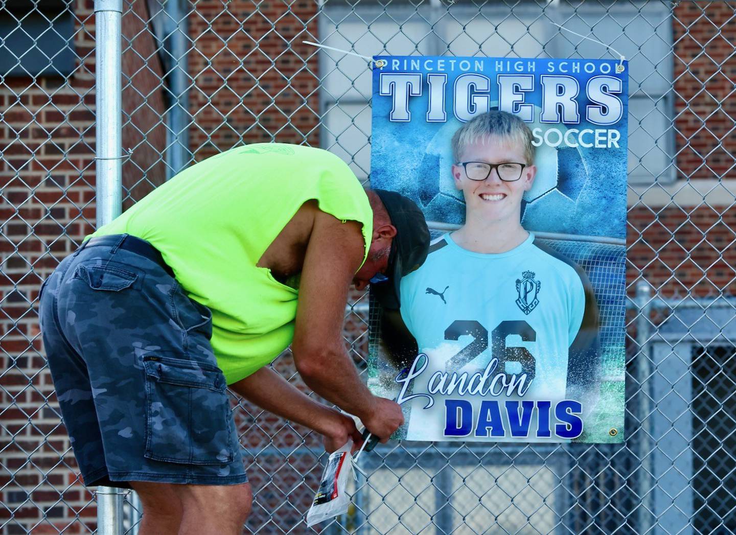 Luke Davis removes the senior banner of his son, Landon, at the end of a Princeton soccer match this season. Landon was the 2025 BCR Soccer Player of the Year for his record-breaking season.