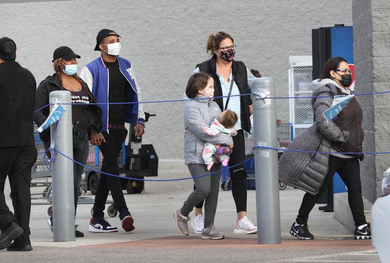 Shoppers in masks once again have to enter the Walmart store on Sycamore Road in DeKalb via the roped pathway Friday Nov. 20 on the first day of tightened restrictions on retailers and other businesses due to the recent surge in COVID-19 cases.