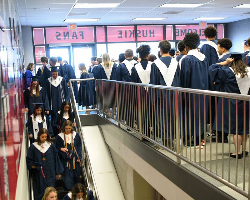 Oswego High School graduates make their way down to Victory Court gym to get last minute instructions before the graduation ceremony on Saturday May 17, 2025, held at the Convocation Center in DeKalb.