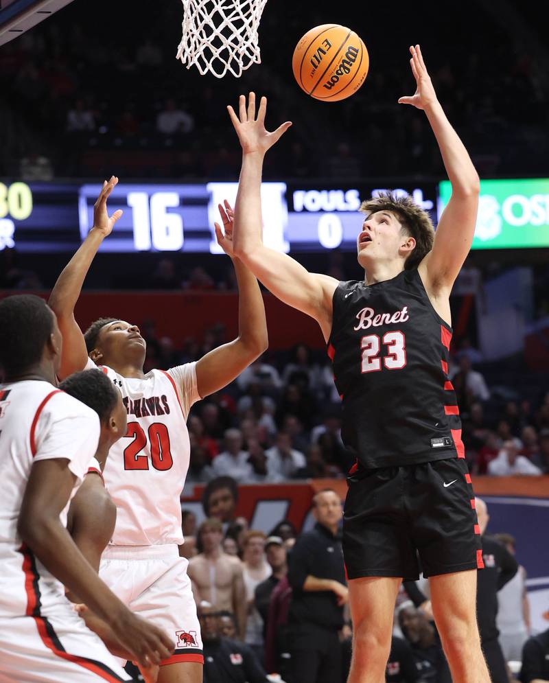 Benet’s Edvardas Stasys grabs a rebound over Marist's Kendall Meyers Saturday, March 14, 2026, during their IHSA Class 4A state championship game in the State Farm Center at the University of Illinois in Champaign.