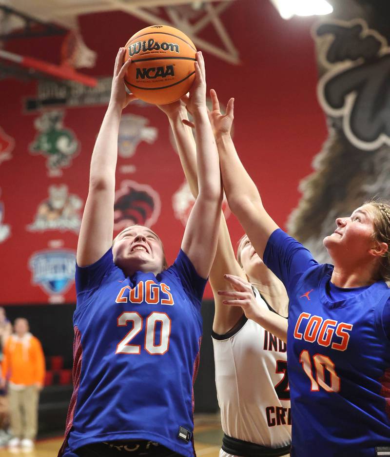 Genoa-Kingston's Olivia Leonforte (left) and Arielle Rich go after a rebound in front of Indian Creek's Gretta Oziah Monday, Dec. 8, 2025, during their game at Indian Creek High School in Shabbona.