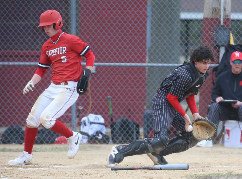 Streator's Colin Byers scores on a error as Hall catcher Noah Plym stops the ball on Tuesday, March 18, 2025 in Foley Field at Kirby Park in Spring Valley.