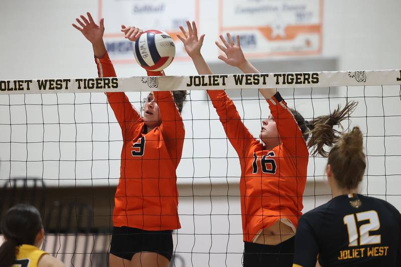 Lincoln-Way West’s Kara Stigter, left, gets the block as Ashley Dace provided a wall also against Joliet West on Tuesday, Sept. 12, in Joliet.